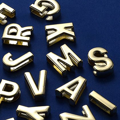 Charms a forma di lettera in metallo dorato Untags