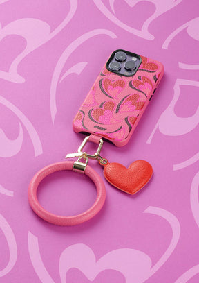 Untags case for iPhone 14 Pro in pink color with hearts and Phone Bangle and charm accessories